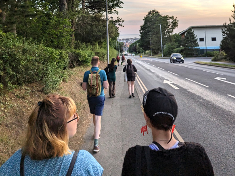 Group of students walking down country lane
